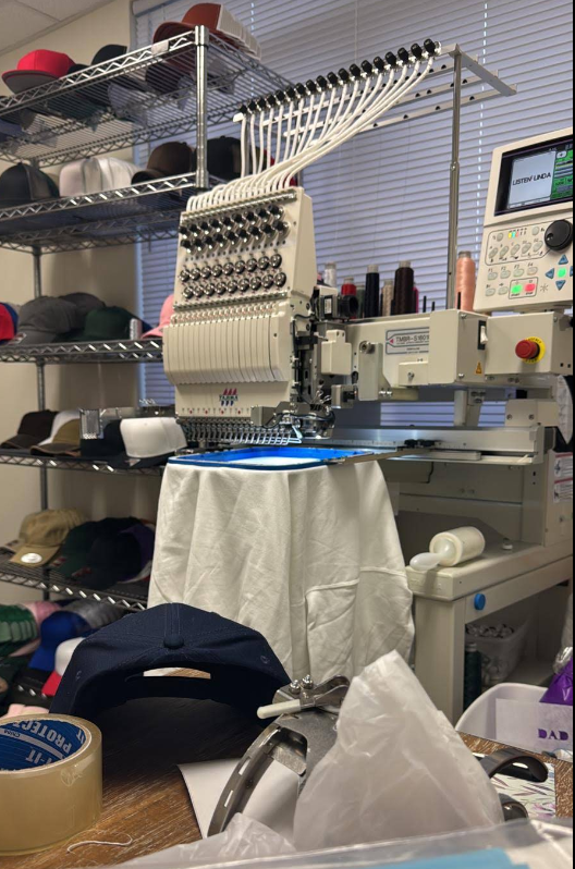 Multi-needle embroidery machine with blank hats at Ayshe Custom Embroidery Studio, Virginia Beach