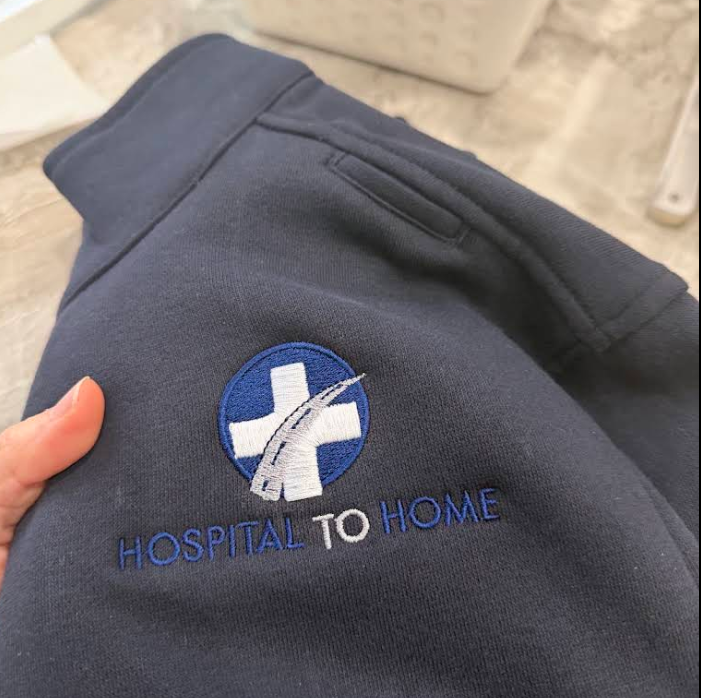 Hospital to Home company logo embroidered on a navy sweatshirt