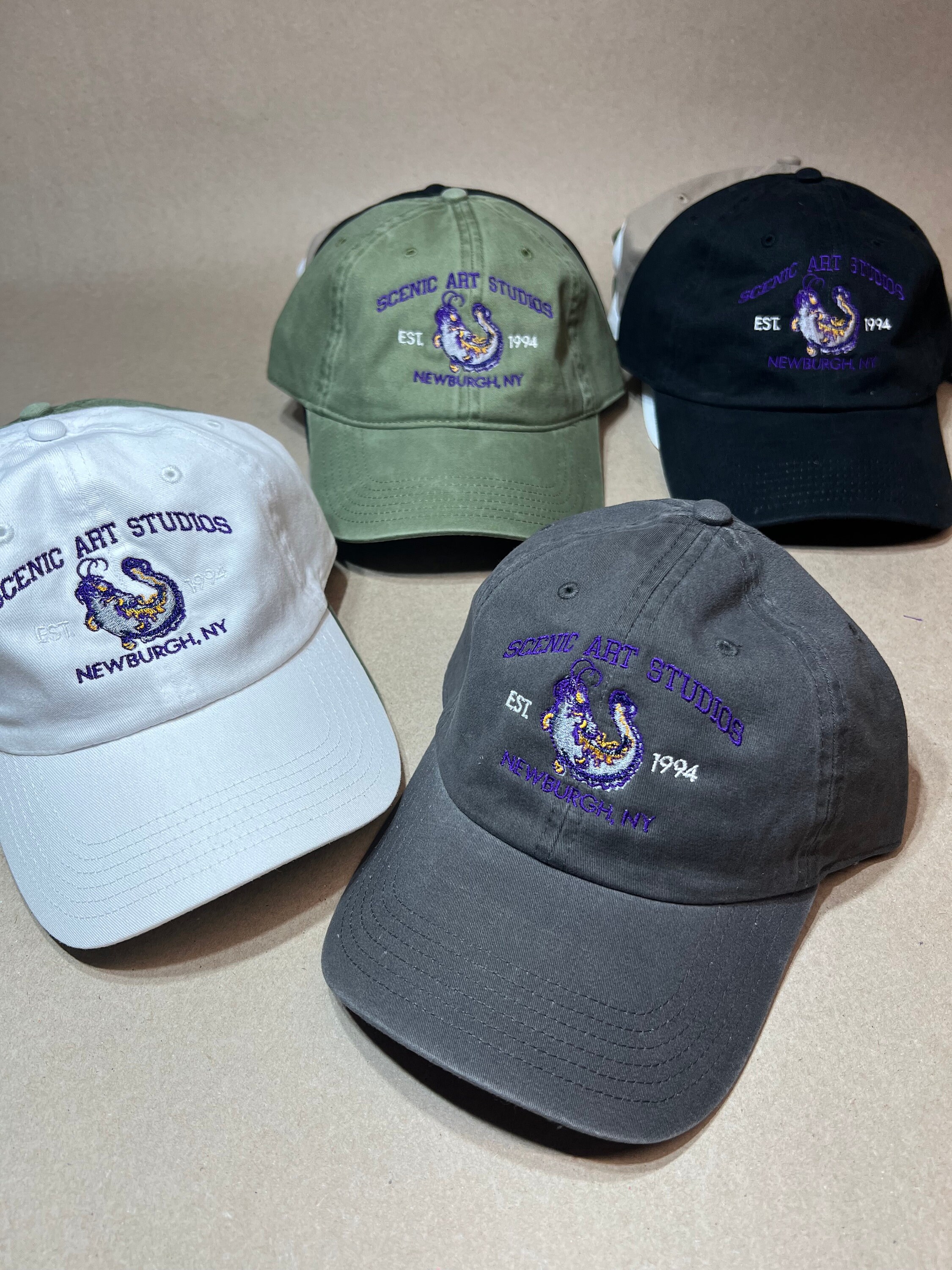 Scenic Art Studios logo embroidered on hats in white, green, black and charcoal