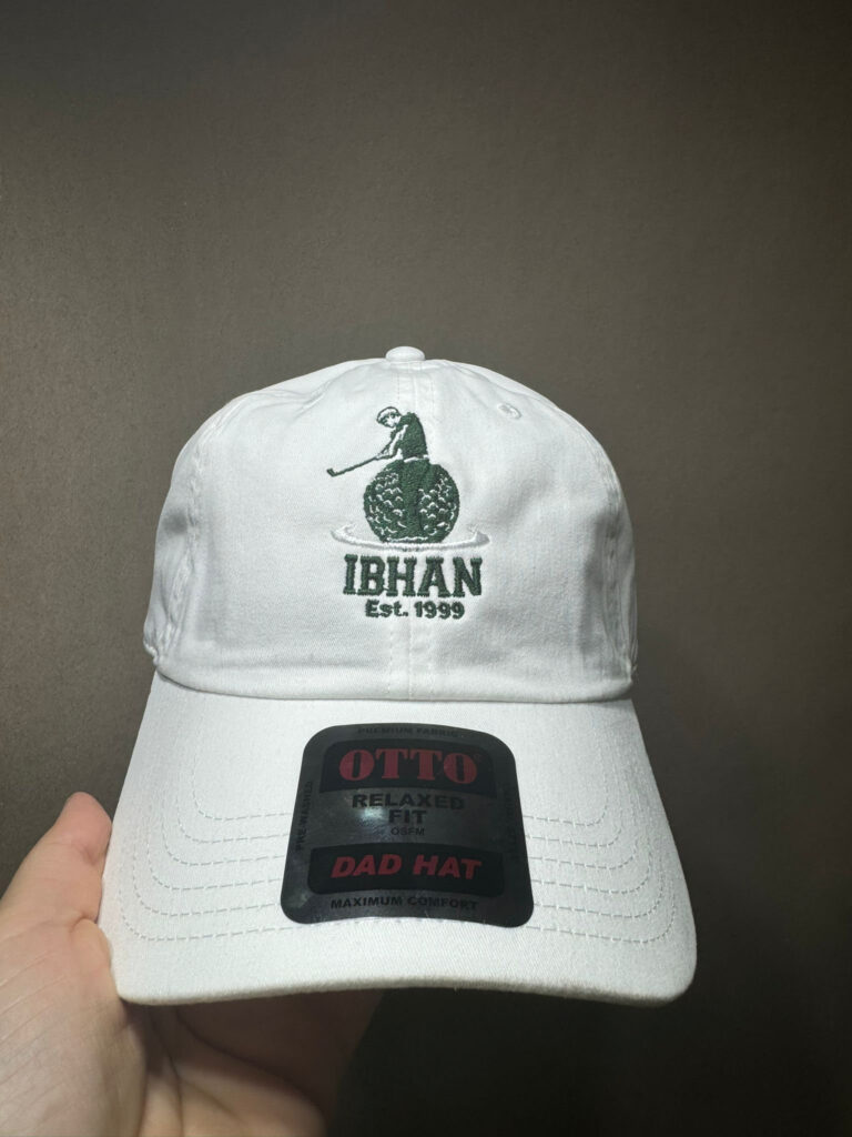 White dad hat with the IBHAN Est. 1999 golf logo embroidered in green